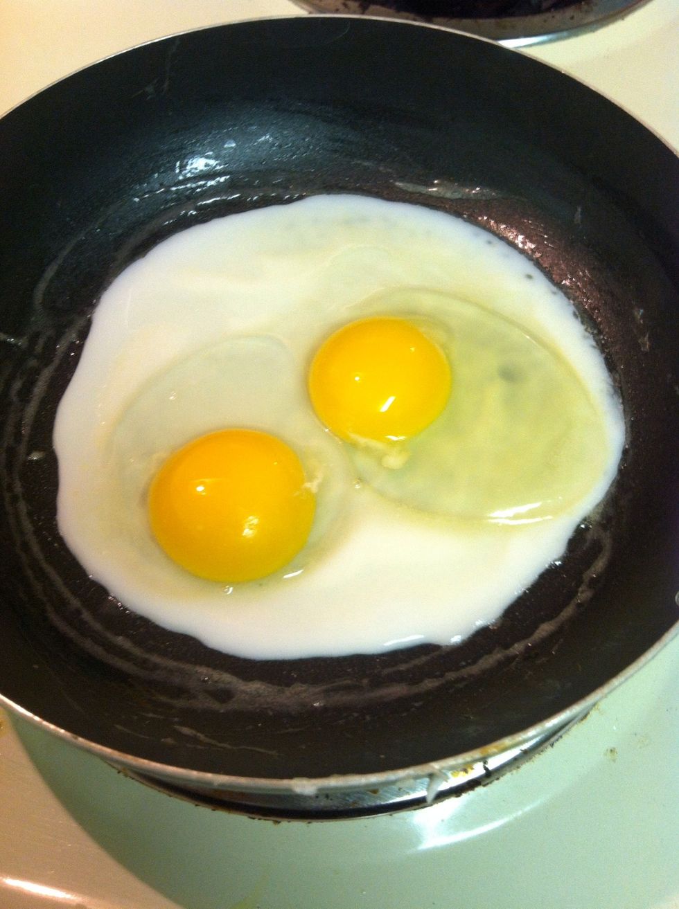 When your pan is heated, Pour in your eggs. They should start cooking right away but not sizzle.