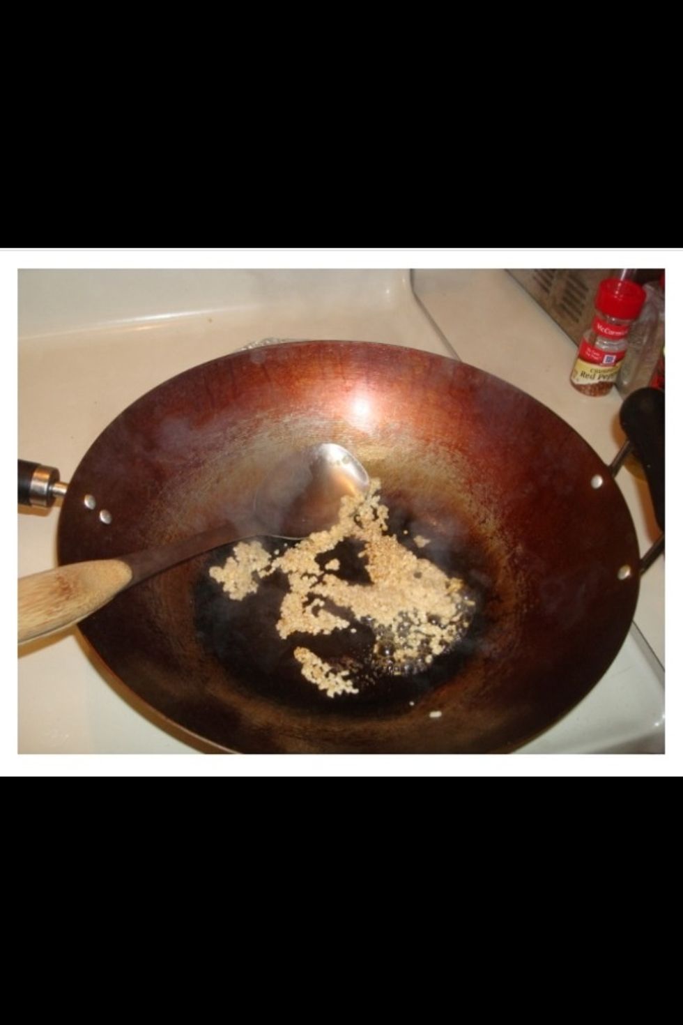 When your rice has about 15-20min left, heat your wok and gather your ingredients.  Begin your stir fry by adding a small amount of stir fry oil to the hot wok and then adding garlic.