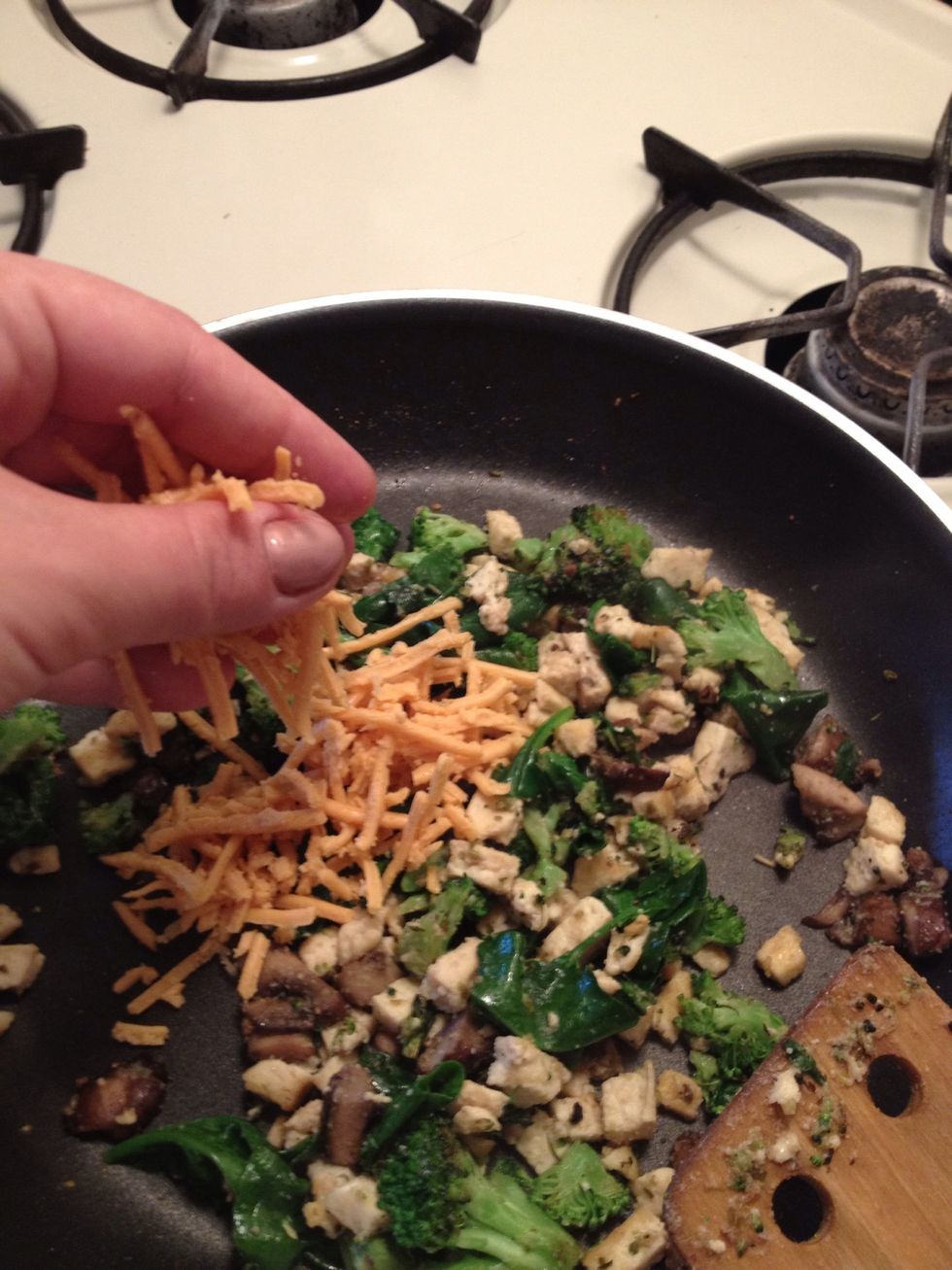 When your spinach has wilted and your tofu has a nice browning color to them, turn off your stove and add the cheeze.