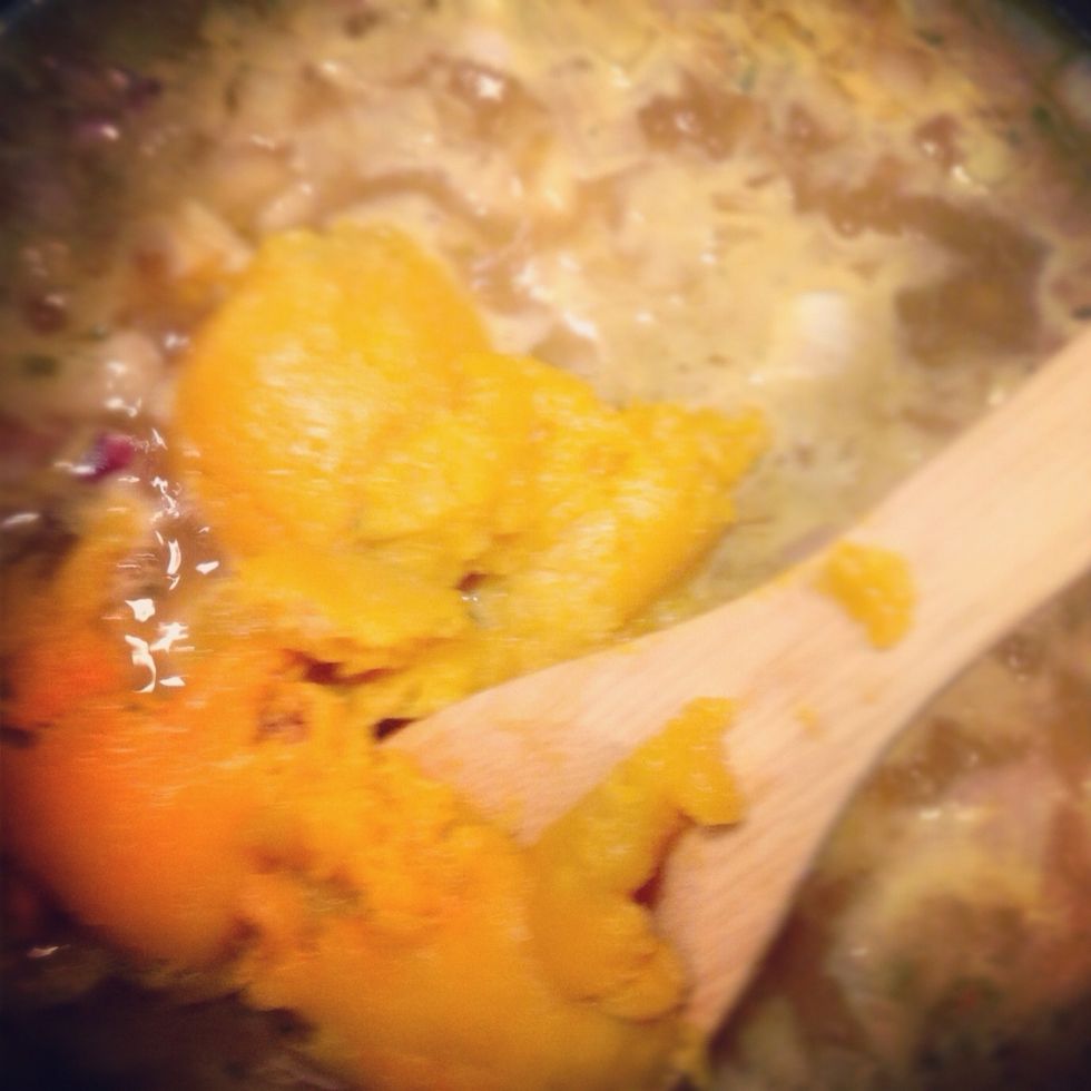 When your squash is ready, take out of oven and scrape with a spoon into pot with onion and stock. Let simmer for 15-20 minutes, stirring occasionally.