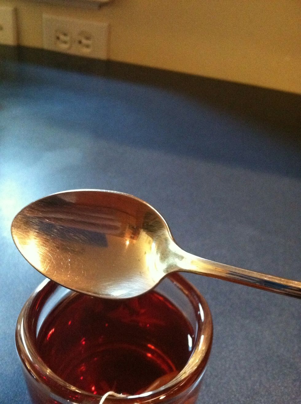 When your tea cools to about 150 degrees (f), remove the spoon