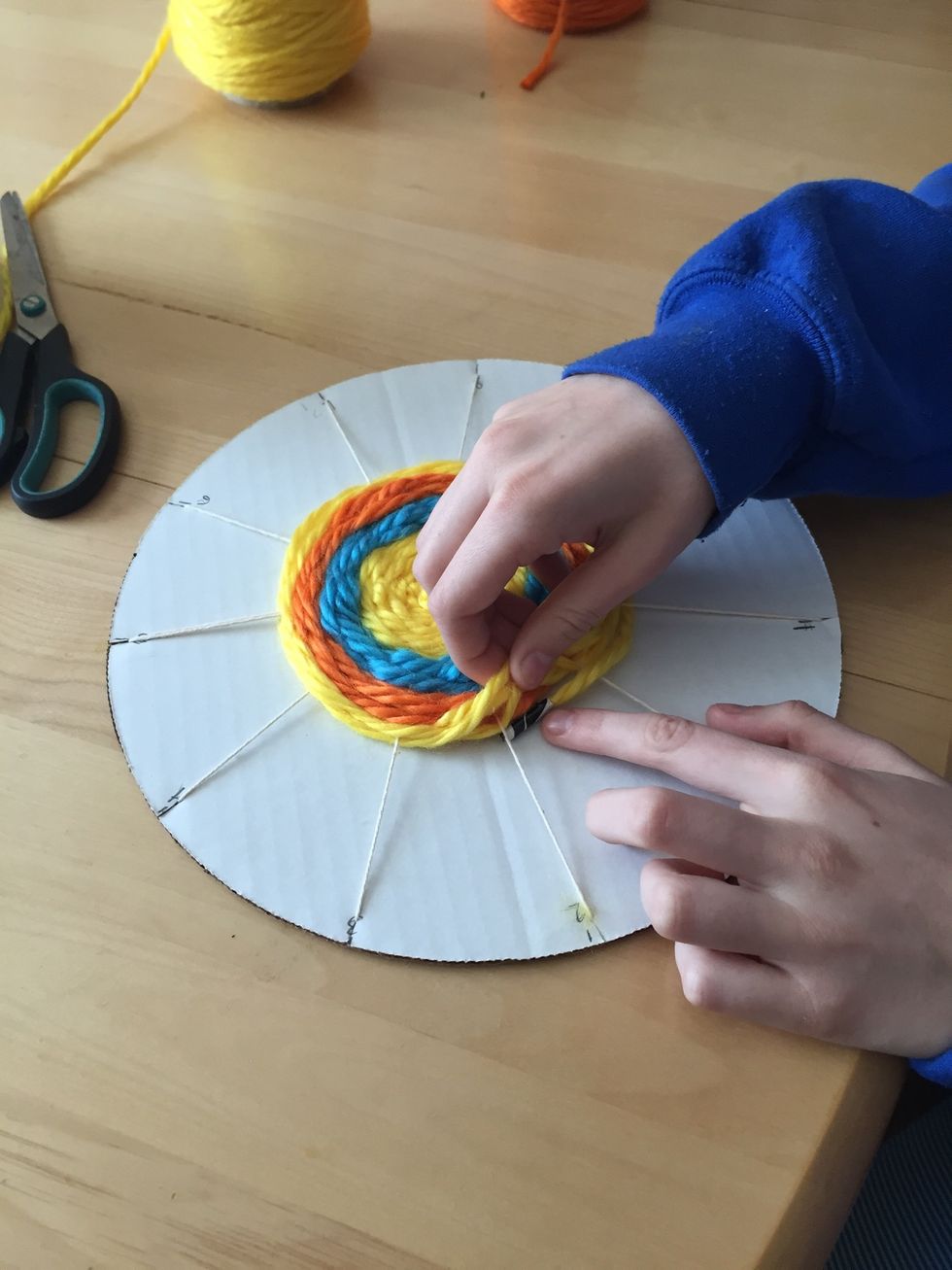 When your weaving is about the size of a baseball, you are finished. Once again, tuck the taped end under your weaving.
