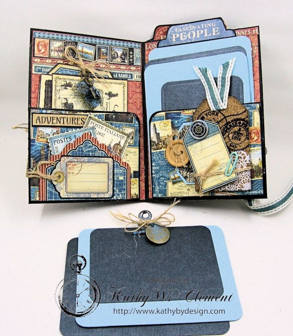 Where you glued the two folders together, you will have a pocket for even more photo mounts. Hold together with a mini clip, and tie a charm to it with burlap string. Tuck in the pocket.