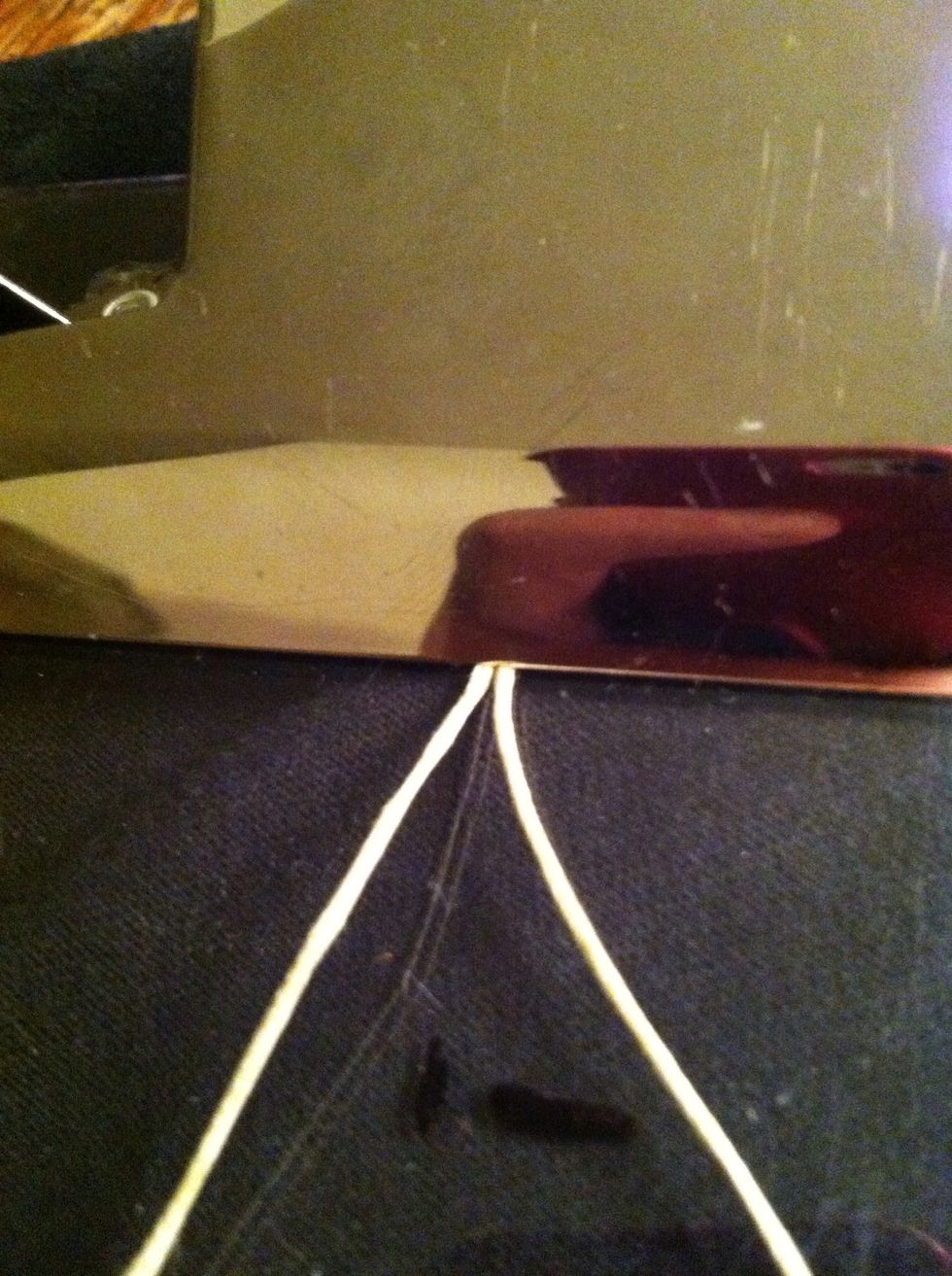 Whether you're using a clipboard or a safety pin, set you two strands up like this. These will always end in the same place. If you tie a knot and the strand ends in the other side it's incorrect.