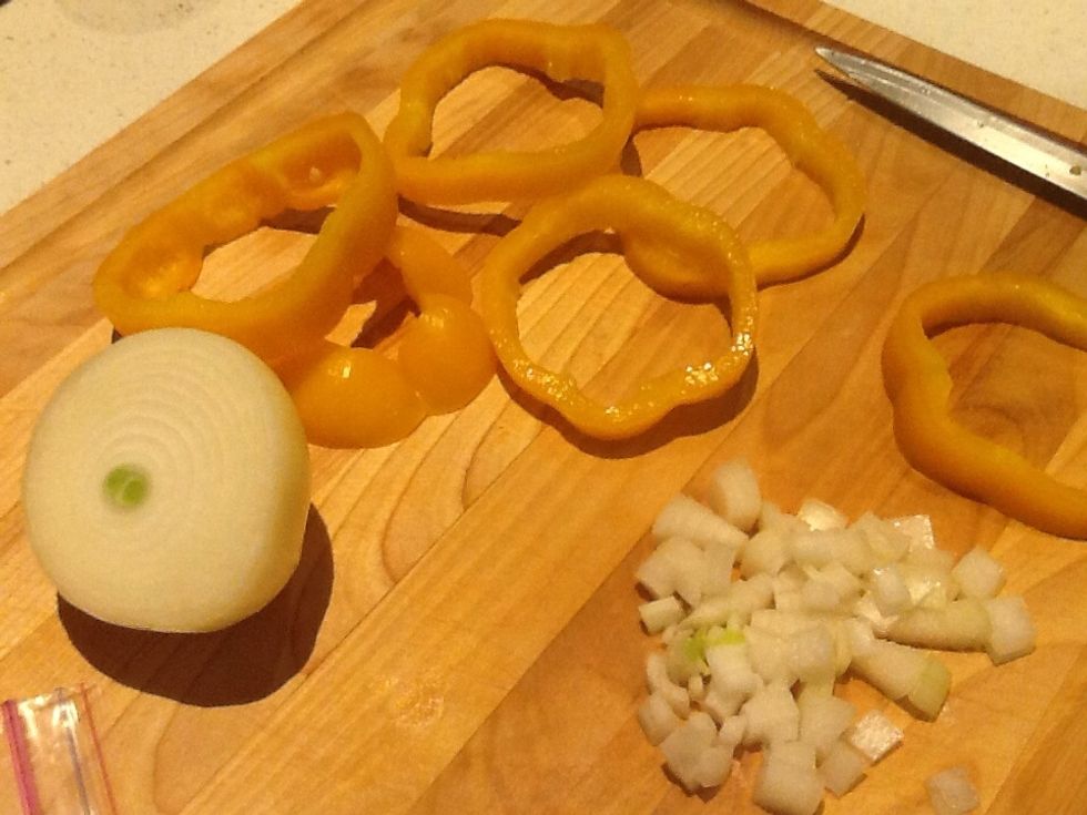 While bacon cooks, chop onion and slice pepper across into circles.