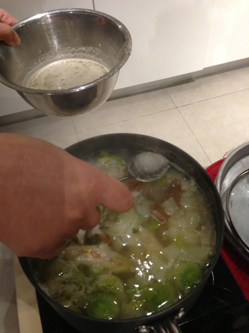 While broth is simmering scoop out the white foam. Do this continuously to get a clear broth