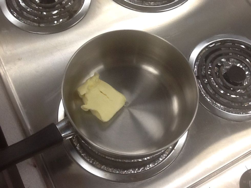 While brownies are in oven make the frosting by first adding butter in a saucepan on a stove.