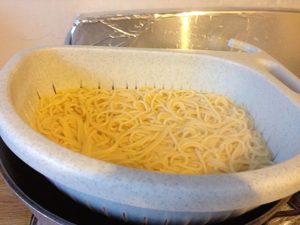 While chicken and sauce cooks, drain your pasta.