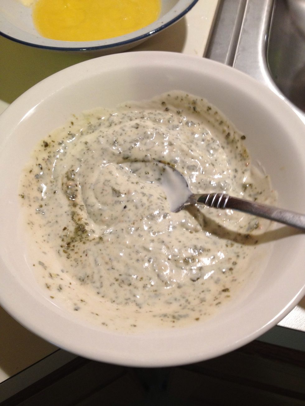 While chicken is cooking, mix together Alfredo sauce and pesto. When finished set aside.