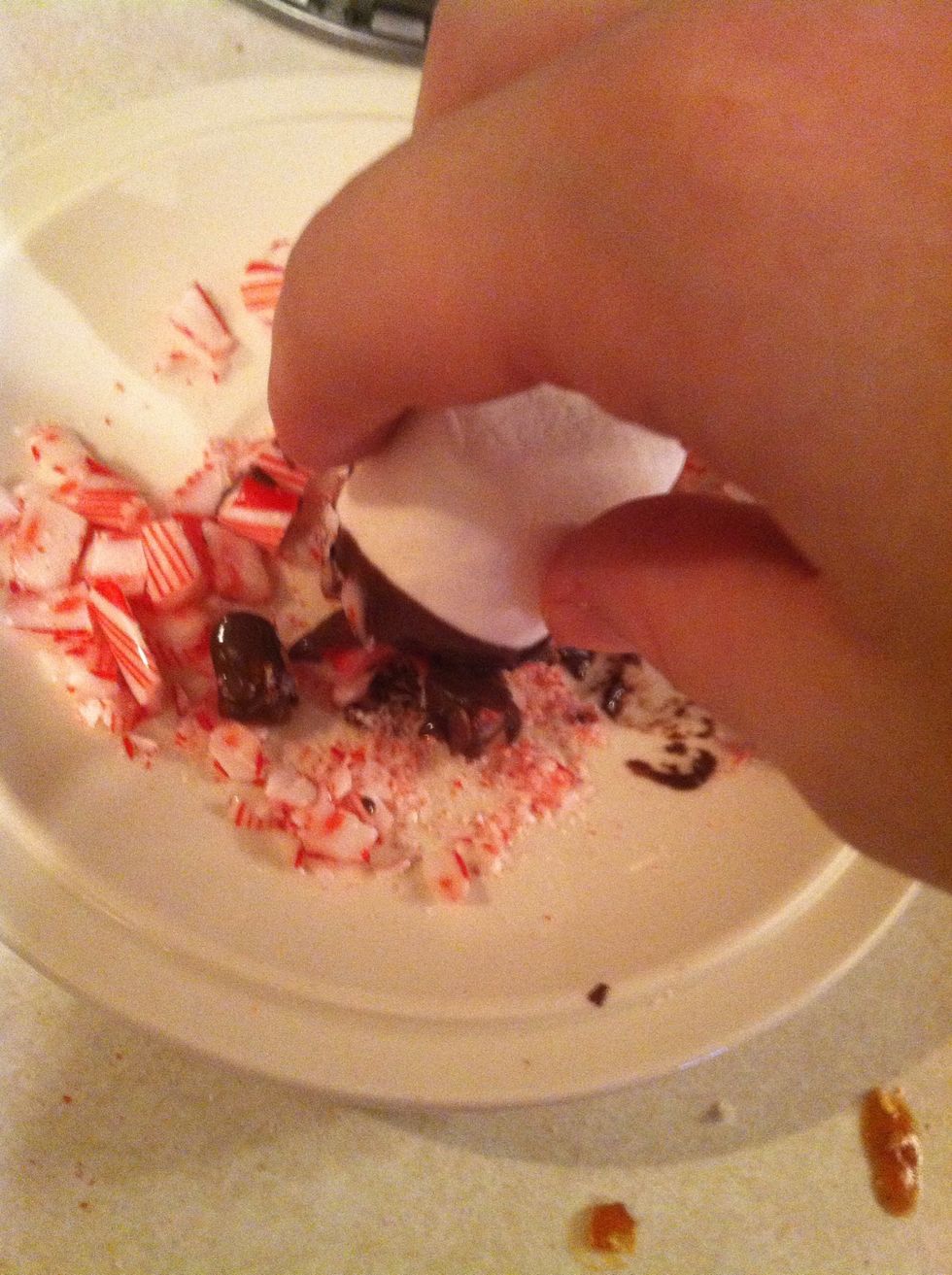 While chocolate is still warm, dip in candy cane pieces.