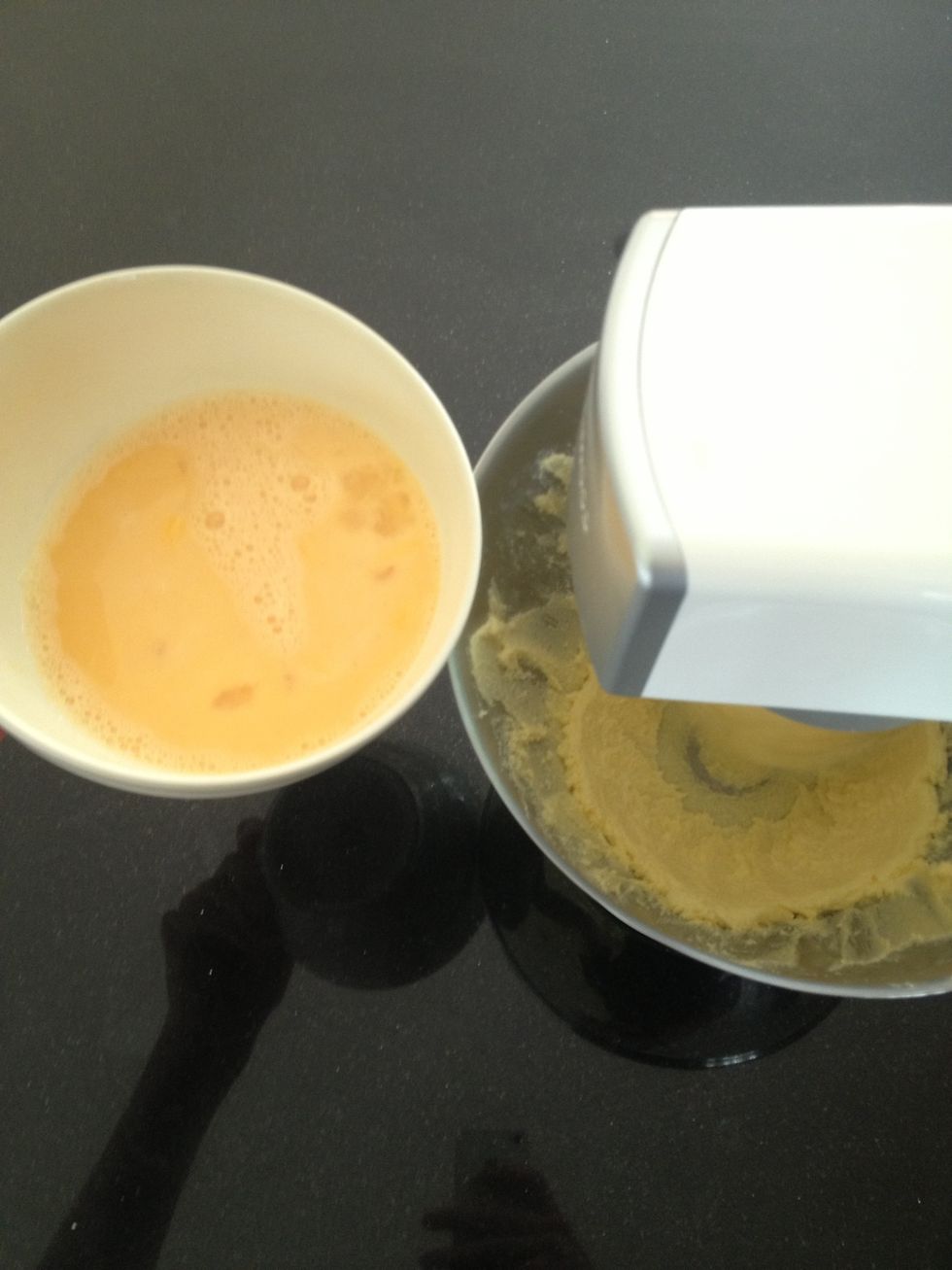 While continuing to beat slowly add the Beaten Eggs a little bit at a time. Scrapping the edges may be needed again.