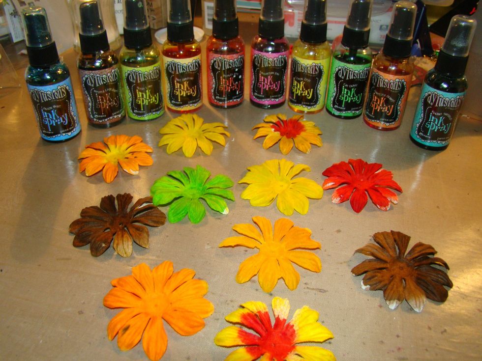 While everything else is drying prepare your flowers. Spray in your custom colors with Dylusions and heat set.