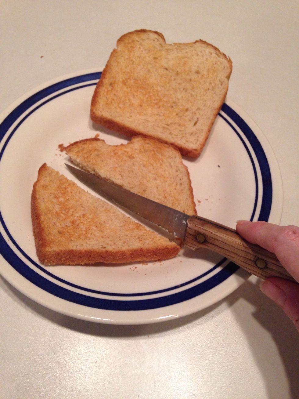 While gravy is cooking, toast bread and cut in triangles, two per plate.