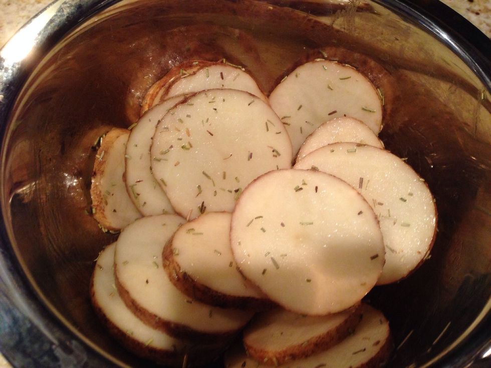 While grill is getting hot, slice the potato into thin slices and toss together with 1 tbls olive oil and 2 tbls rosemary.
