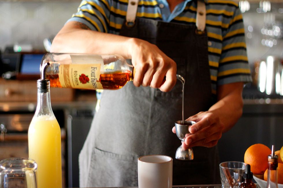 While it's heating, add your Bourbon and lemon juice to a mug.