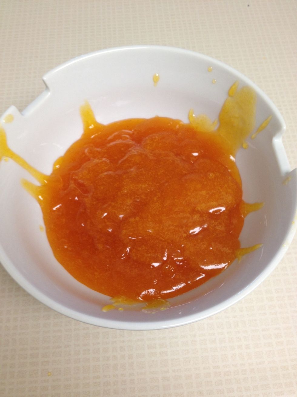 While layers are cooling, heat the apricot preserves (I just popped it in the microwave for about a minute) and strain.