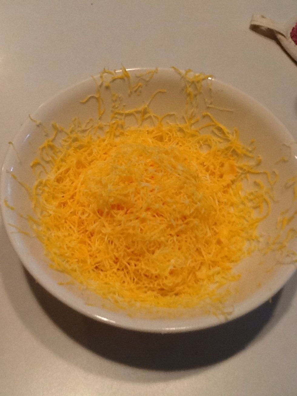 While macaroni is cooking, shred cheese (or you can buy it already shredded.)