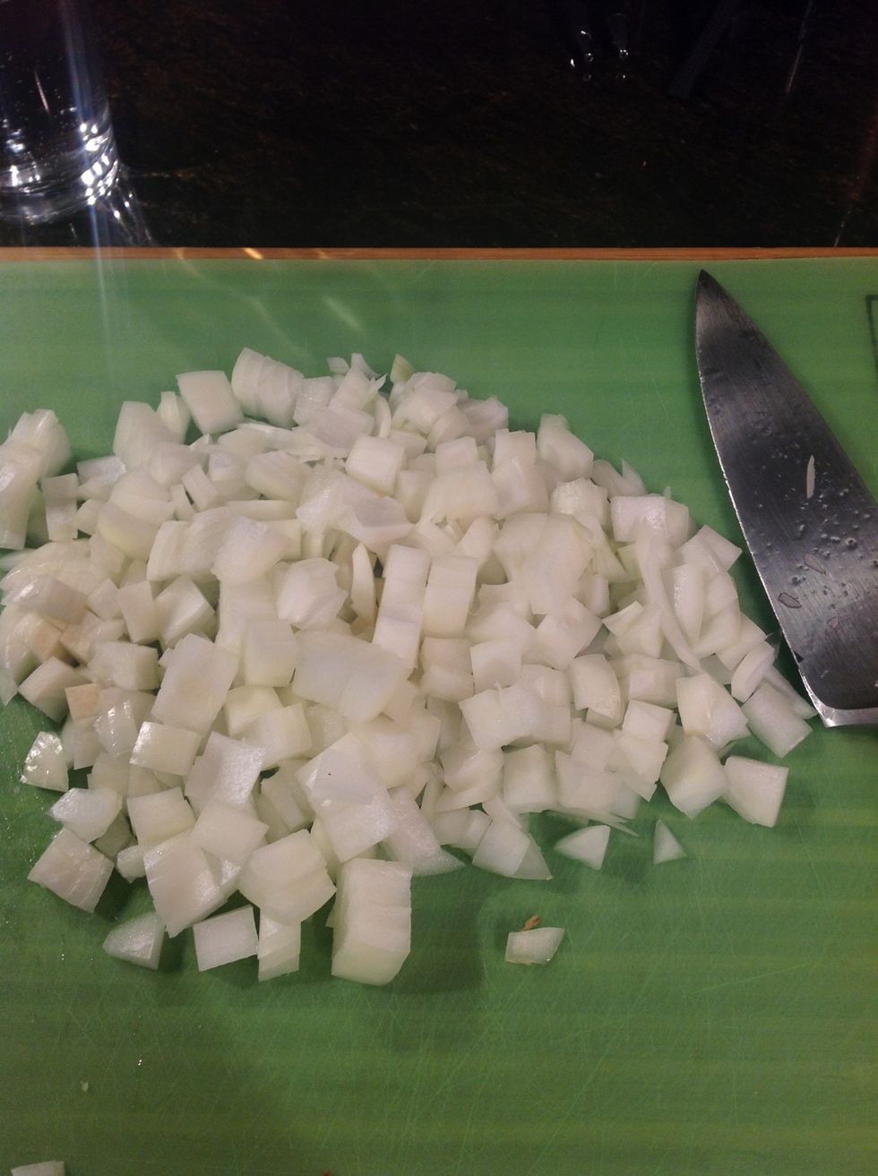 While meat browns chop onions to a medium dice.