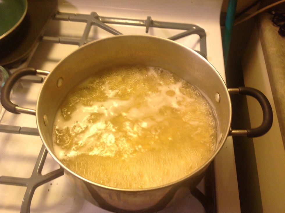 While oven is warming up, bring the elbow macaroni to a boil in water with three tablespoons of dried onion flakes.