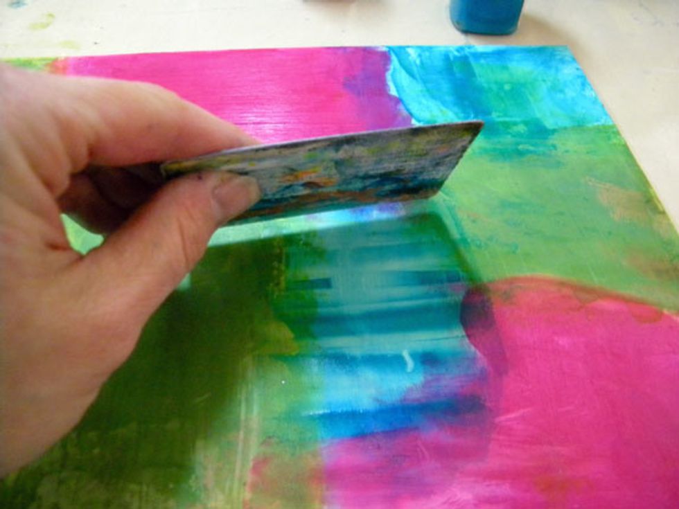 While paint is still wet, drag a key card through the blocks, overlapping the colors.