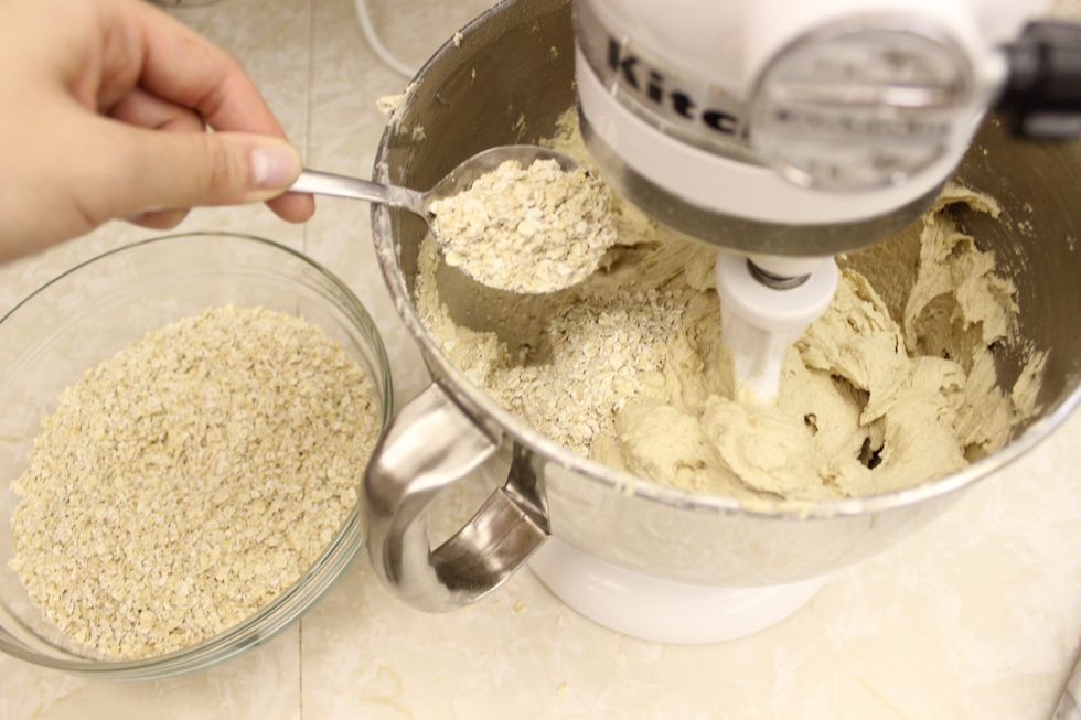 While running on low, slowly spoon in the rolled oats. Stir until well incorporated.