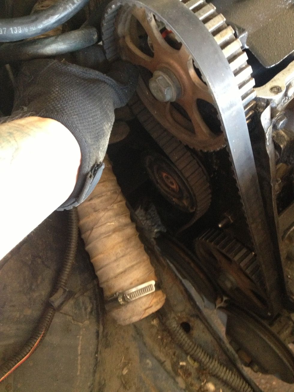 While sliding the belt off the camshaft pulley