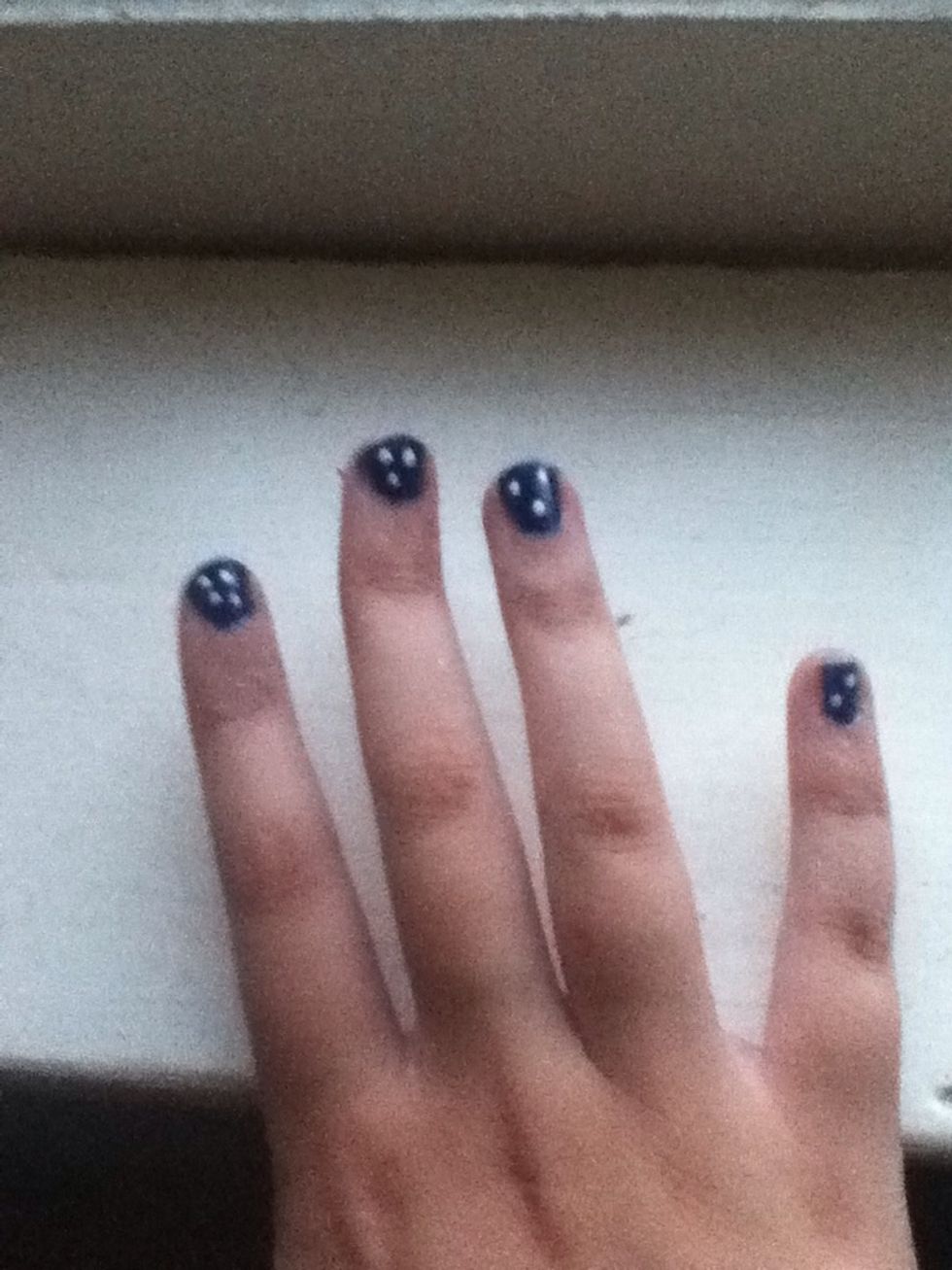 While that dries, take the time to add dots to your other free nails. These could represent stars, ghost faces, or whatever you like. Don't be afraid to make each nail different.