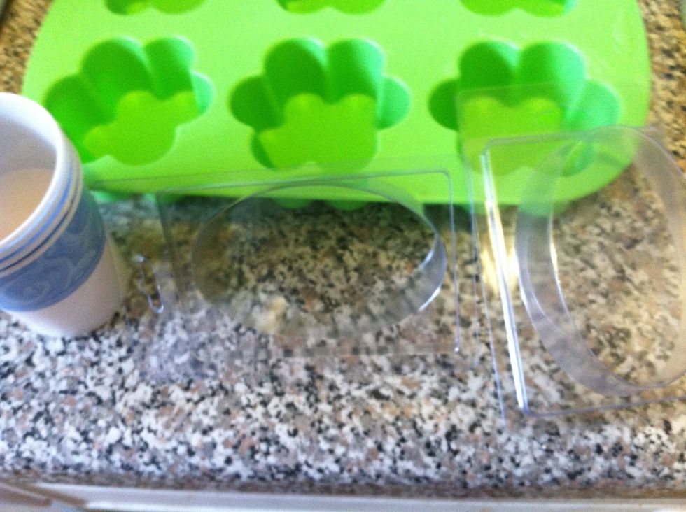 While that is microwaving or melting in the double broiler, choose your molds. I bought clamshells (pour in mold, snap on the back, & you can sell them), silicone flower molds, and more Dixie cups.