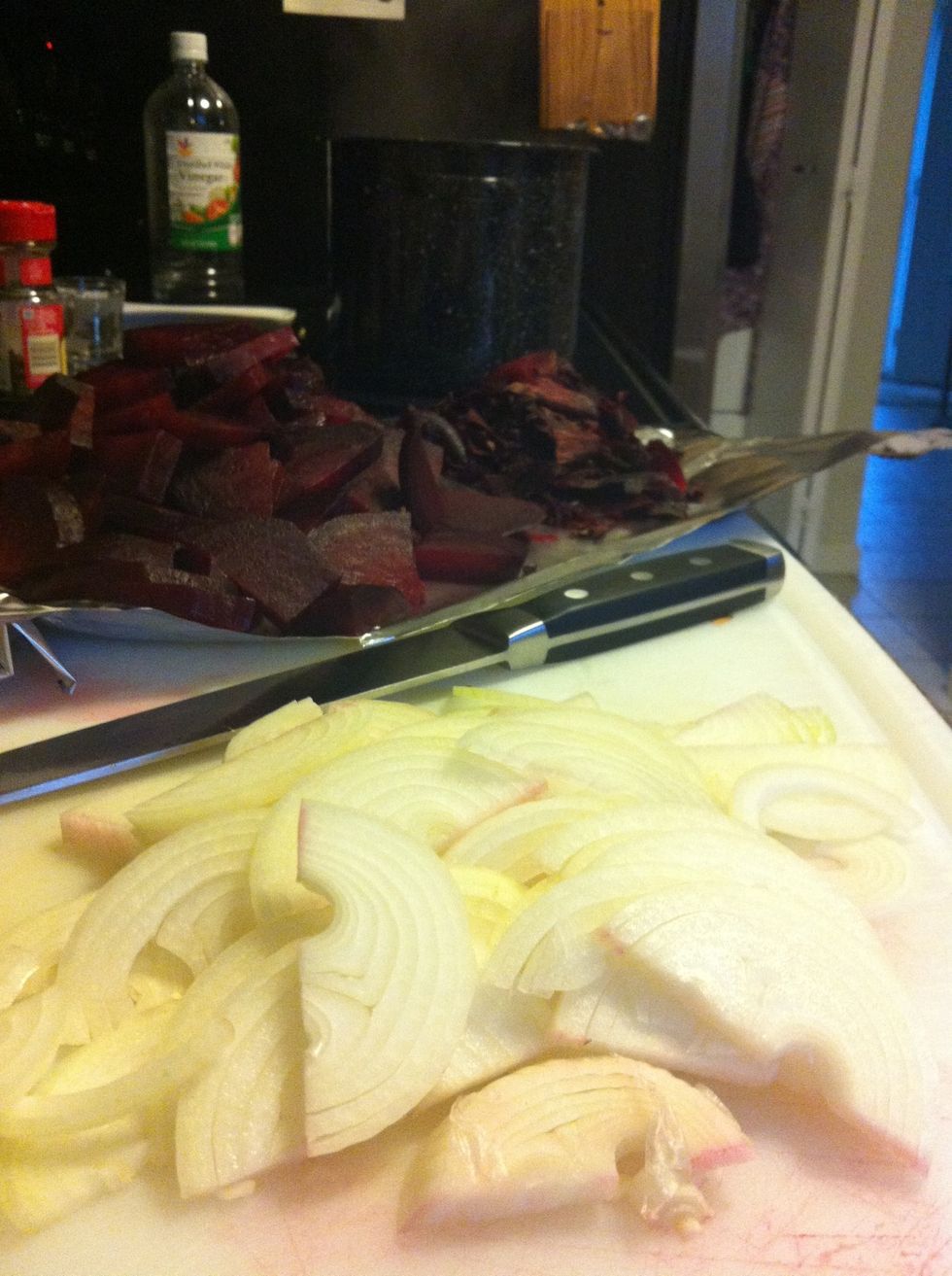 While that simmers and becomes lovely; half and thinly slice 2 small onions