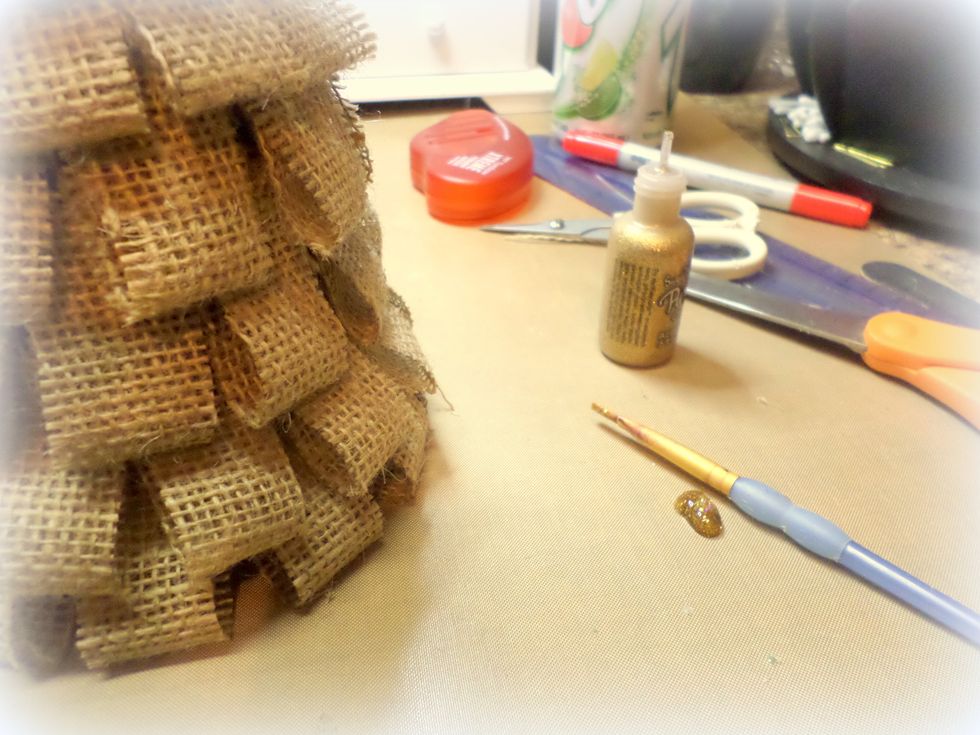 While the adhesive was drying, I added some gold Stickles. I like to apply it with a paint brush so I just squeezed some out on my craft mat.