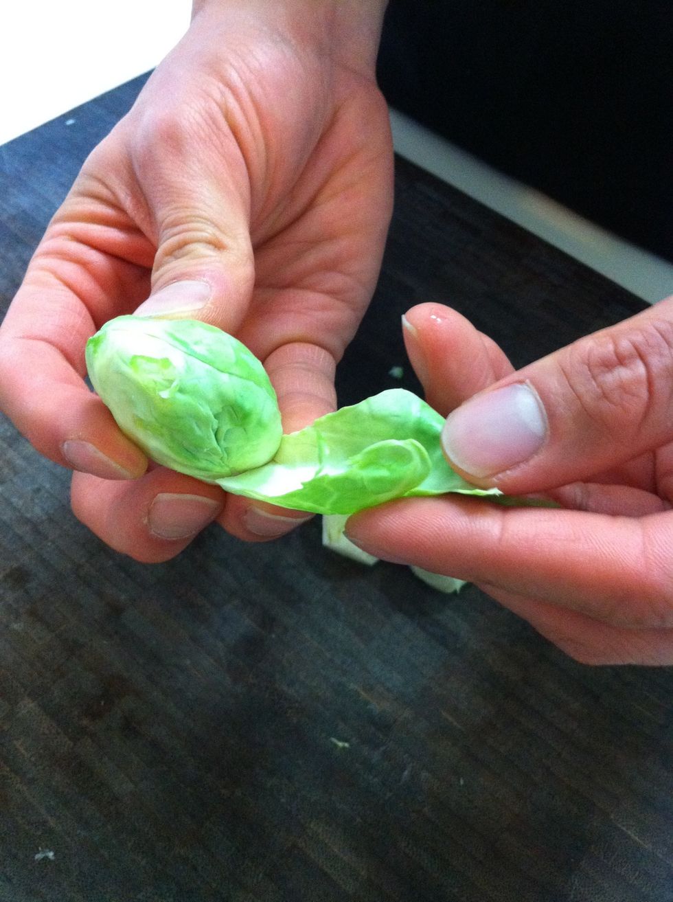 While the bacon is cooking, you can prep the brussels sprouts. Start by removing and discarding the first few damaged or dead leaves on each sprout