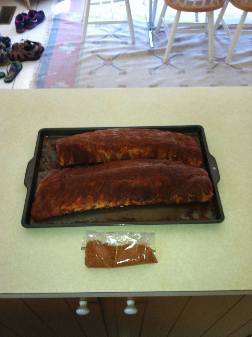 While the charcoal is coming to temperature, remove the ribs from the refrigerator.  They should have given off some liquid and caused the rub to form a paste.  Add some more of the rub.