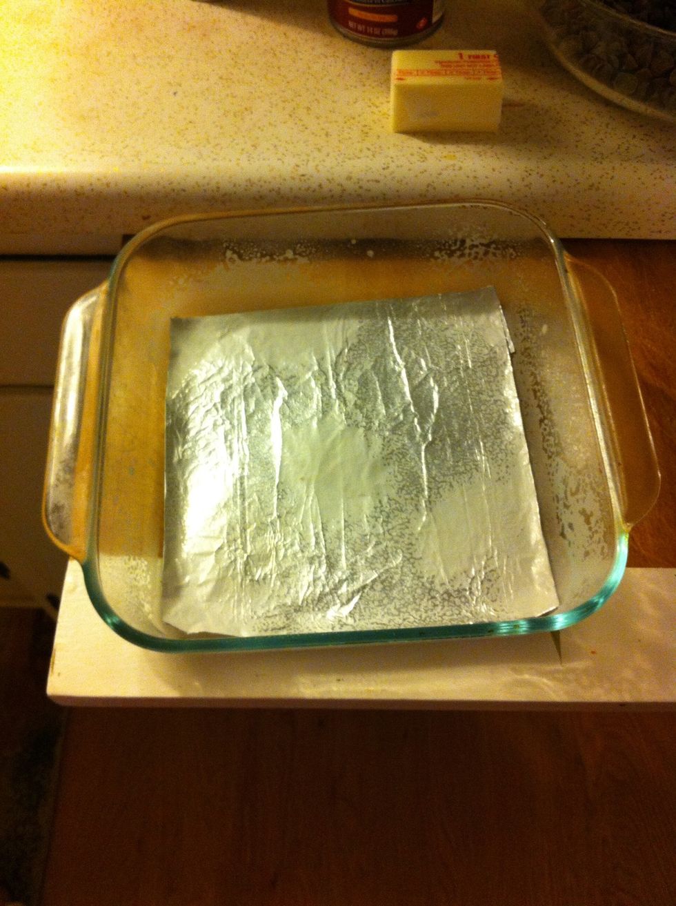 While the chocolate is cooking place foil on bottom of pan and spray with cooking spray.