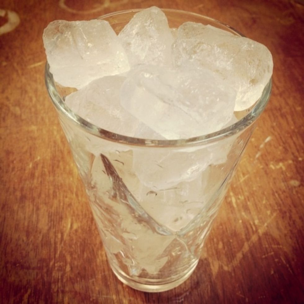 While the coffee finishes dripping, get your glass and add 215g of ice.