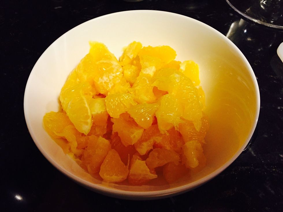 While the cranberries are cooking, section 4 oranges removing the pith and cutting into small pieces.