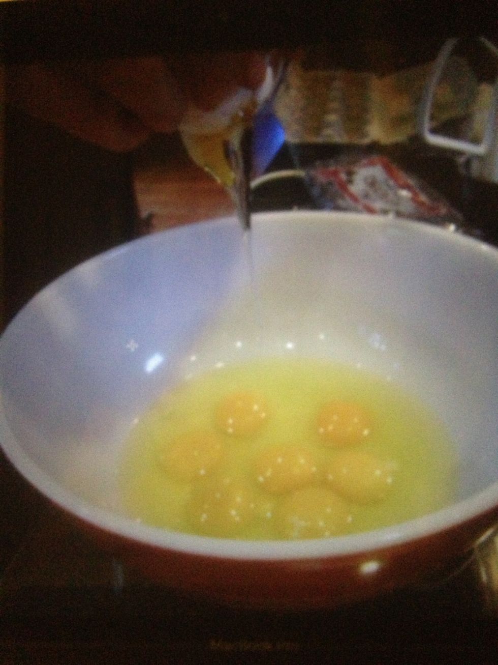 While the crust is baking, crack the eggs into a bowl