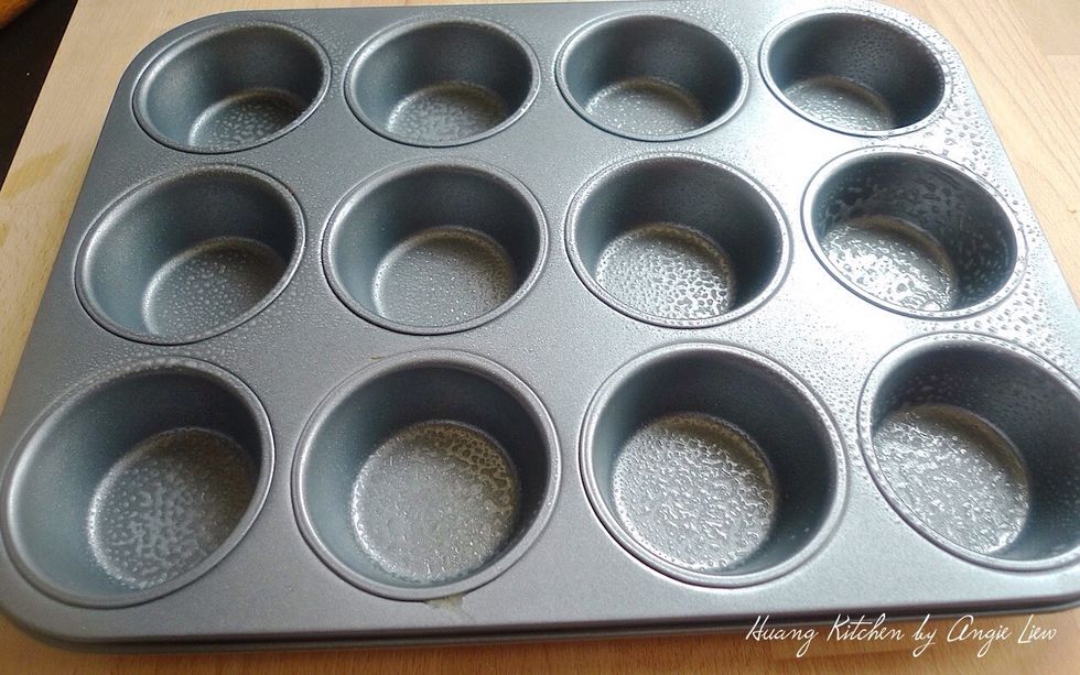 While the dough is resting, lightly greased 12 muffin cups.
