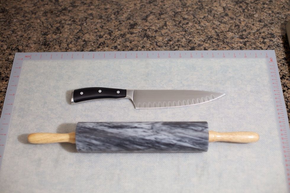 While the dough is rising, get your rolling pin and knife ready.  I roll the dough out onto a silicone mat so I can cut directly on it.