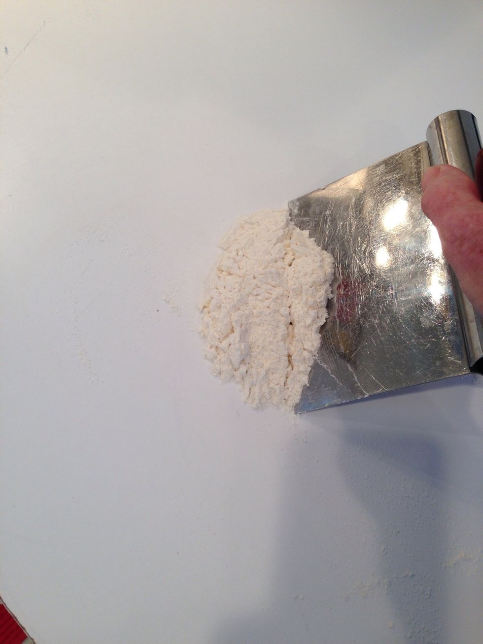 While the dough rests, prepare the counter again. Scrape the counter and re-sift the flour onto it. There may be bits of dried dough- toss those. Add flour, as needed to cover.