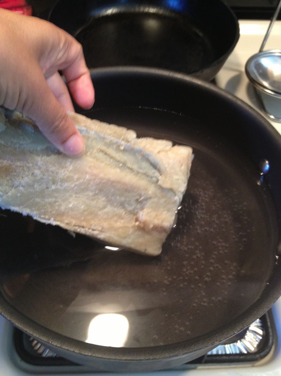 While  the eggplant is roasting , lets boil our codfish to remove the saltiness,let this boil for 15min.
