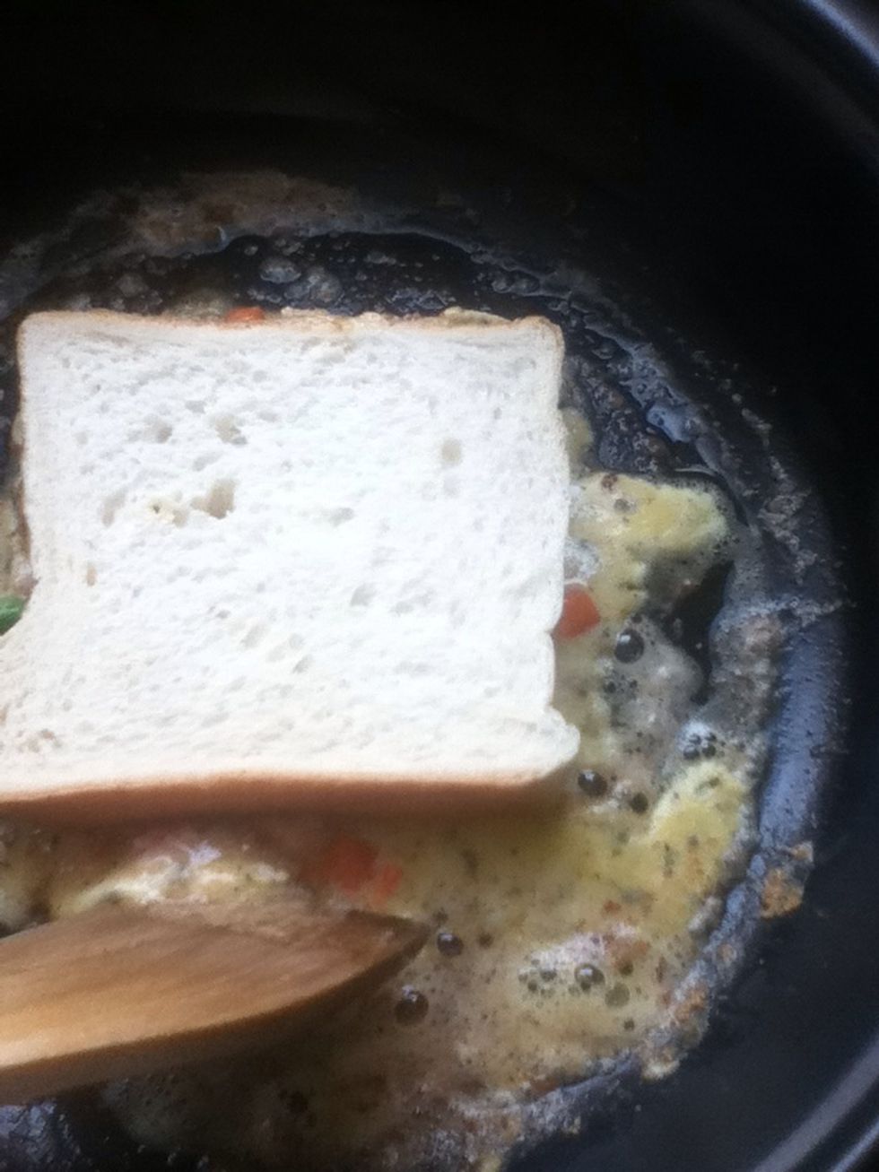 While the eggs mixture are cooking, flip the excess part of it to the side of the bread to make it look prettier..and yummier :D