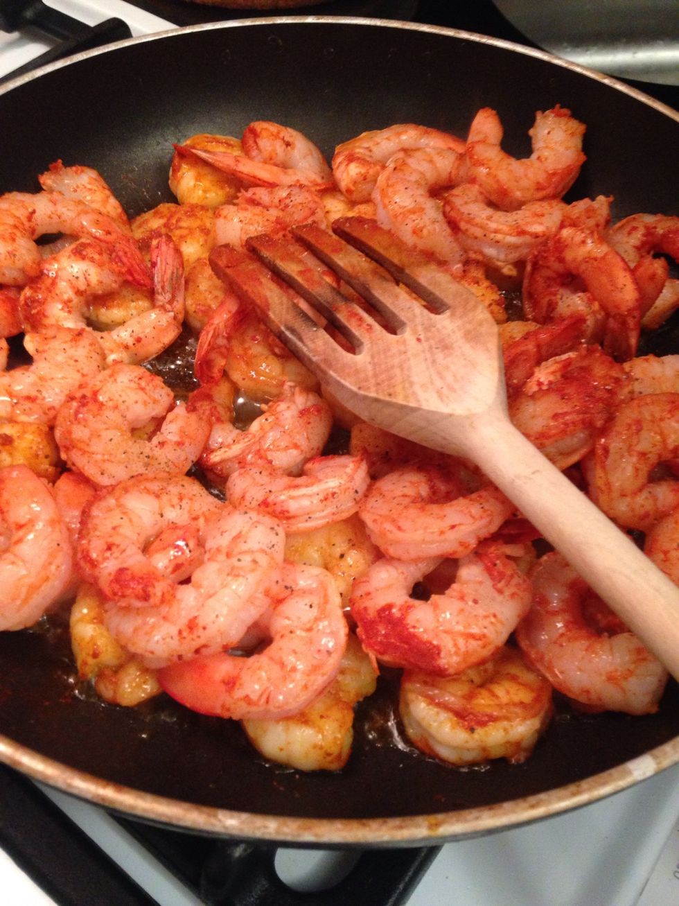 While the grits cook - in a large pan add the spiced shrimp - cook flipping occasionally 2- 4 min - transfer to a plate wipe out the pan