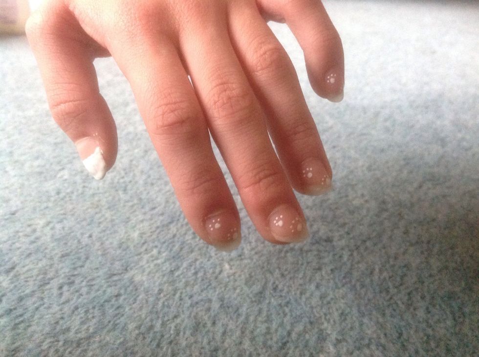 While the head is drying with your white nail art pen again draw paw prints on the rest of your nails. You can do as many as you like depending on the size of your nail. I did two!