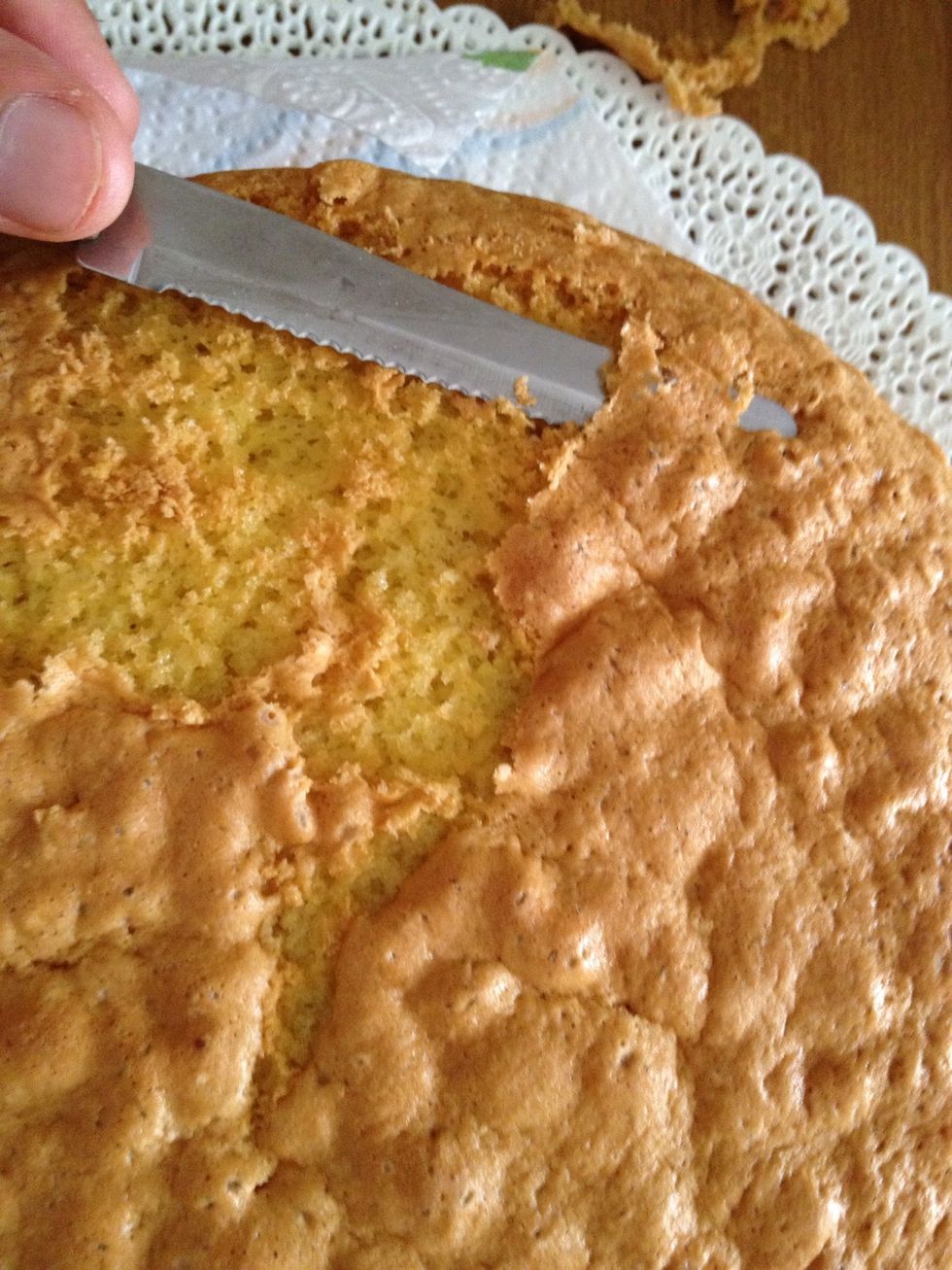 while the lemon cream is cooling cut the top and bottom of the base cake because it contains a lot of butter
