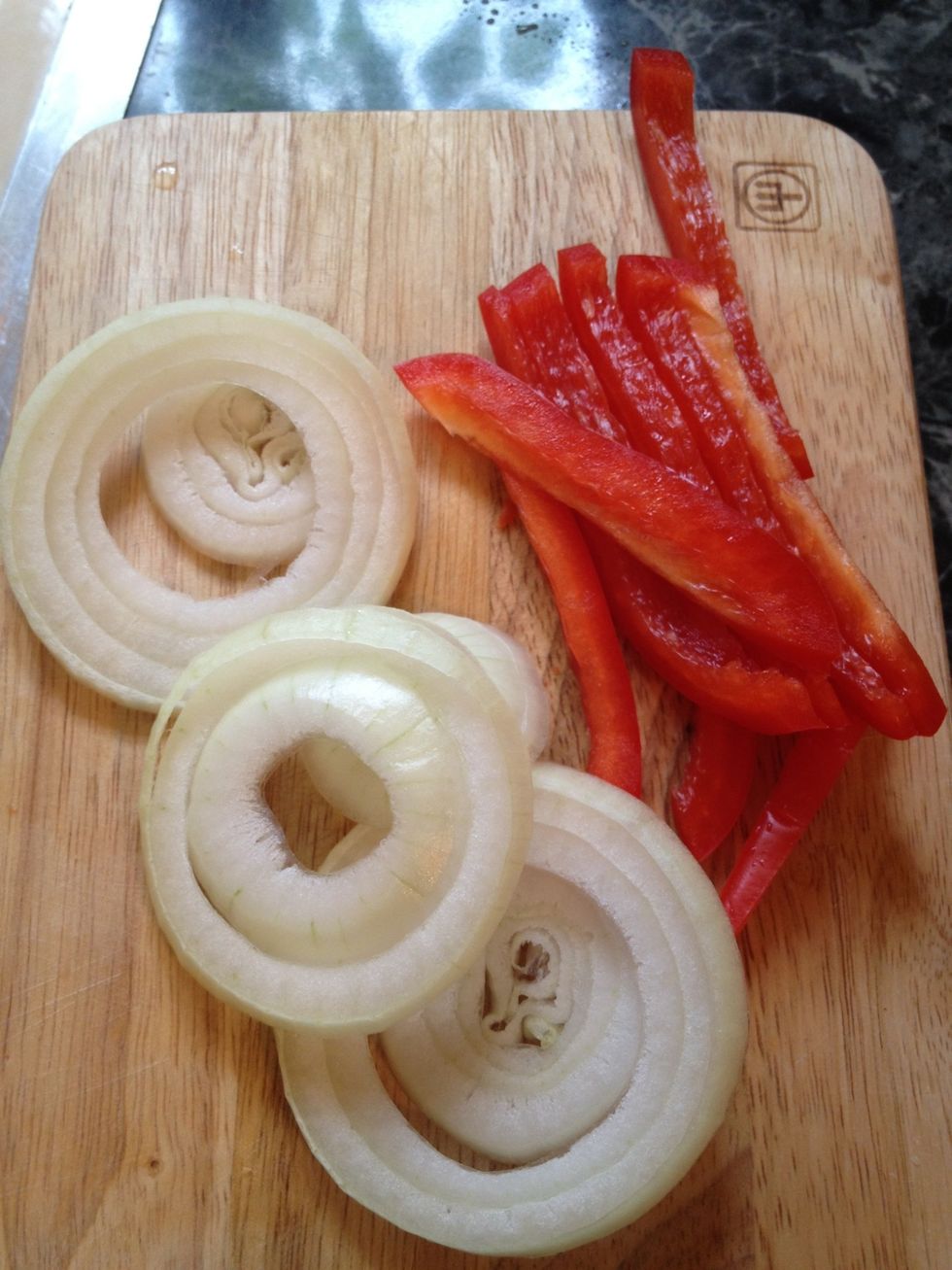 While the meat balls are frying slice up some onions and peppers and set them aside.