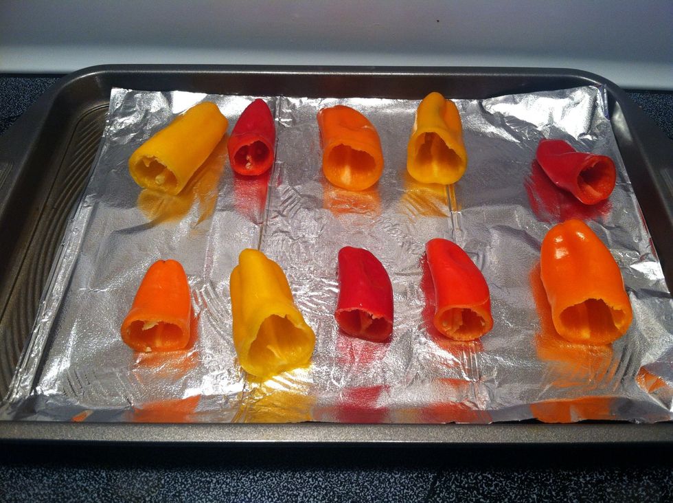 While the meat is cooking, cut pepper tops and remove seeds, then place on foil.