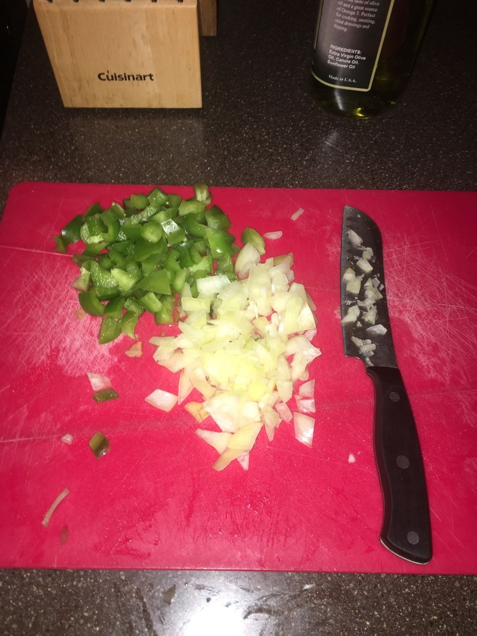 While the meat is cooking, cut up a half of an onion and half of a green pepper.