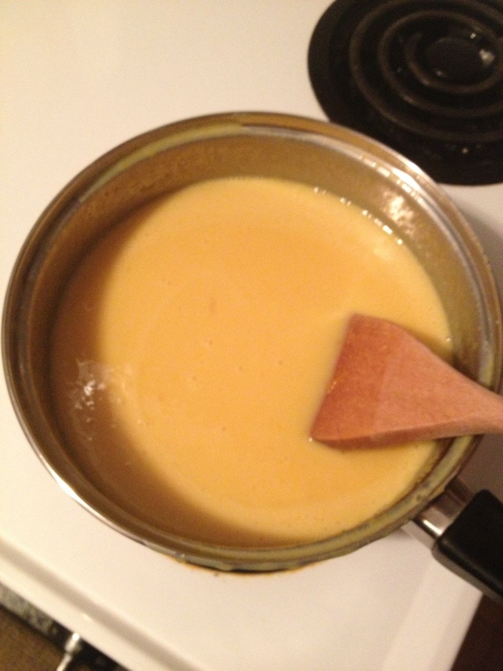 While the meringue is baking, make the filling by combining the egg yolks, vanilla extract and condensed milk in a sauce pan.