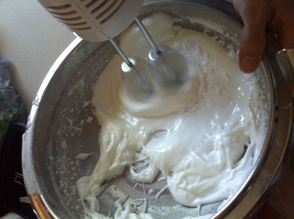 While the mixer is still on high speed, add granulated sugar to egg whites form slowly.
