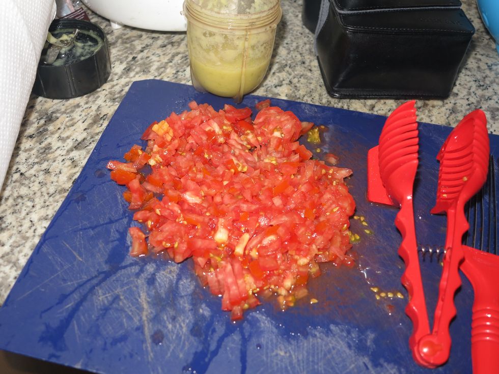 While the oil is heating, dice the tomatoes and keep aside.